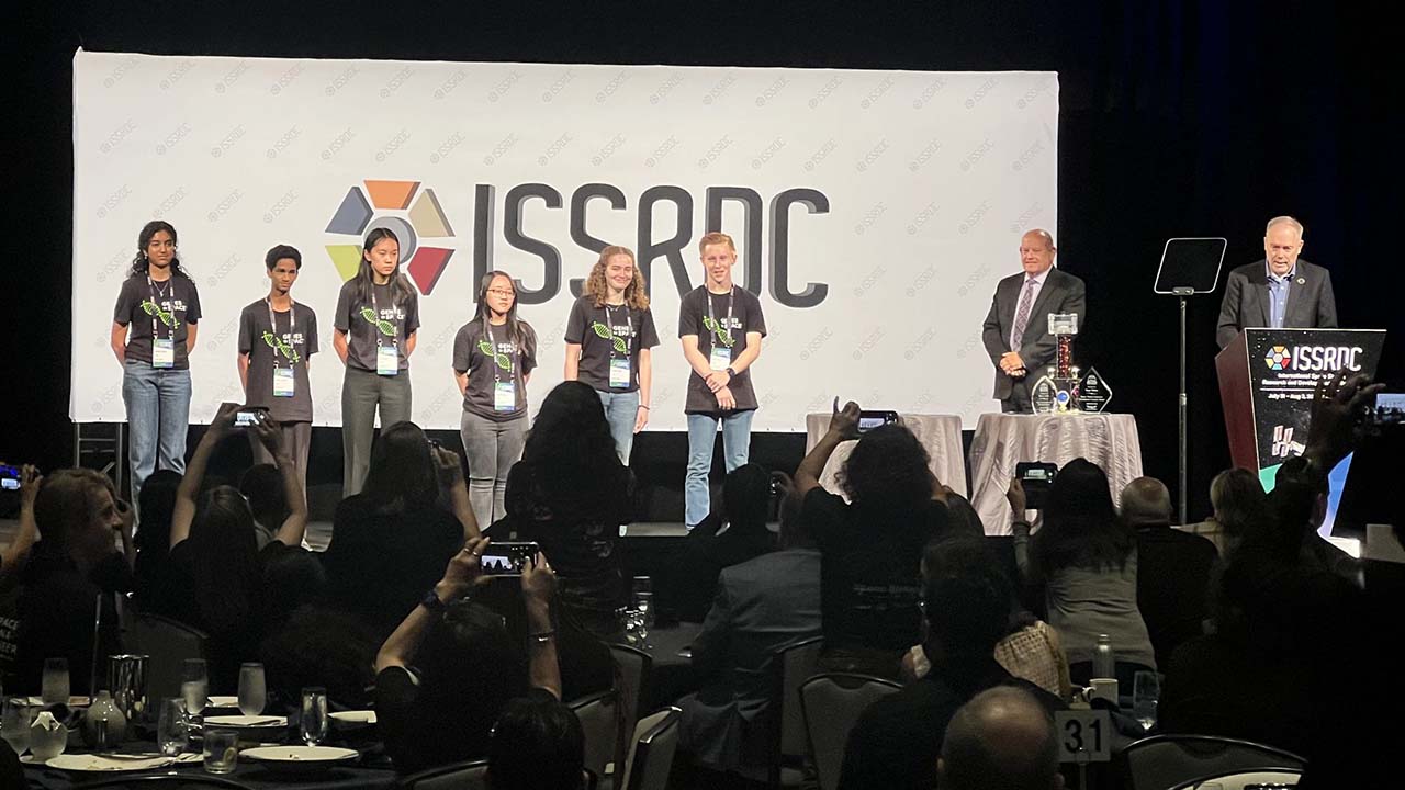 The 2023 Genes in Space competition finalists on the stage at ISSRDC 2023.