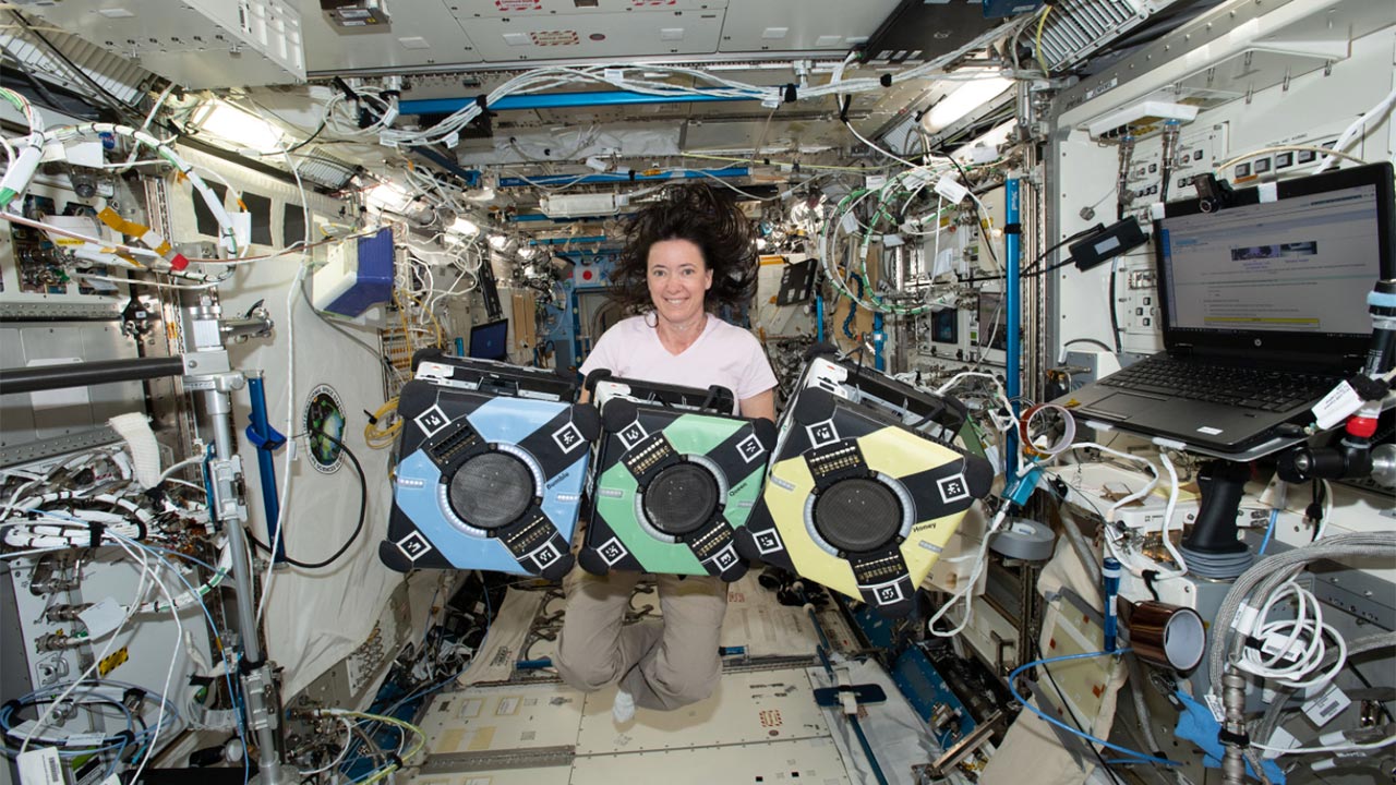 NASA astronaut Megan McArthur with the Astrobee robotic free-flyers.
